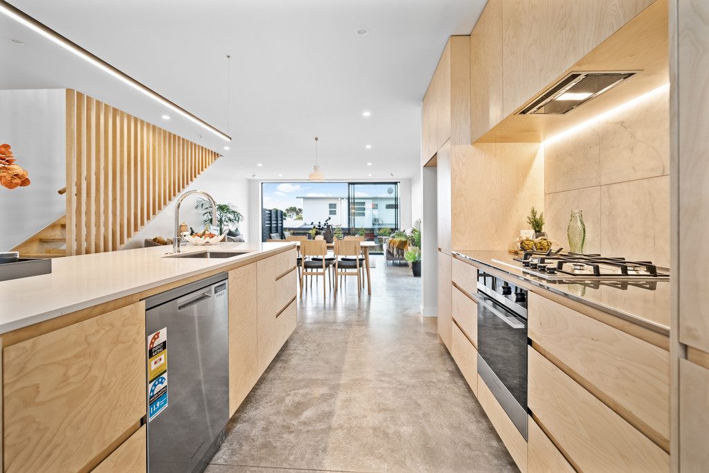 Light wooden kitchen with aluminiun sliding door