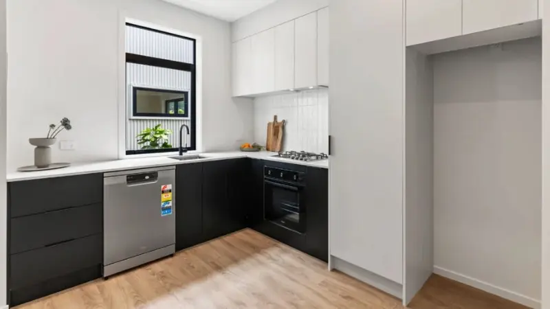 Modern townhouse kitchen with aluminium awning window providing natural light and ventilation
