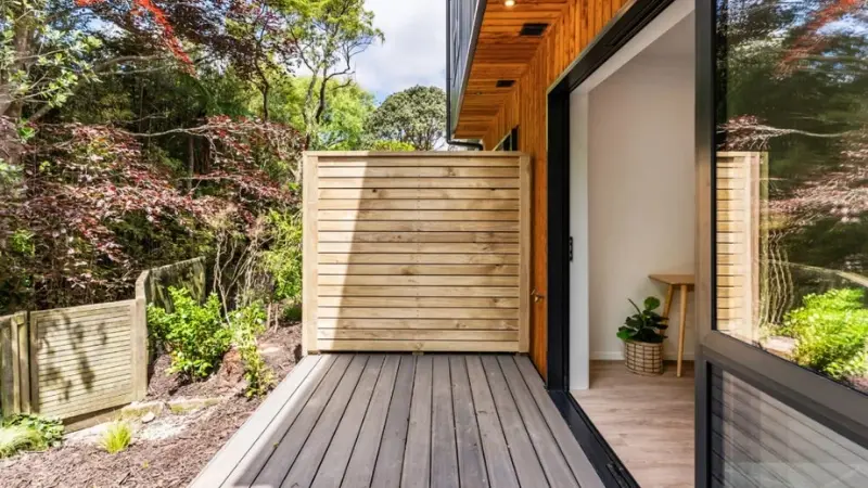 Outdoor deck area with aluminium sliding door connecting to interior living space in multi-residential townhouse