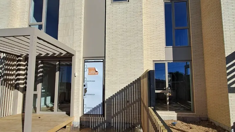 Exterior view of 30 Milton Road during construction showing aluminium windows and landscaped outdoor areas.