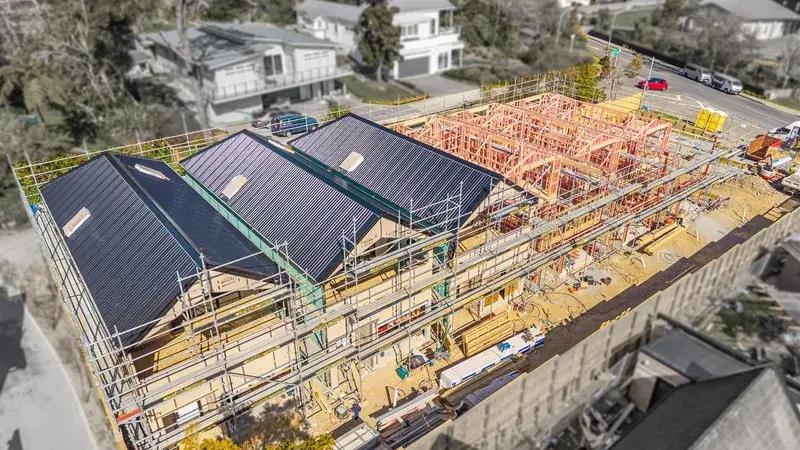 Aerial view of 41 Whitemans Road under construction in Upper Hutt, with roofs complete on three townhouses and framing underway on the rest.