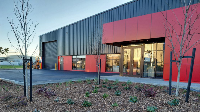 Exterior office entrance at Bascik Transport in Palmerston North featuring UNO Commercial and UNO Non Thermal aluminium windows and doors in Matt Flaxpod.