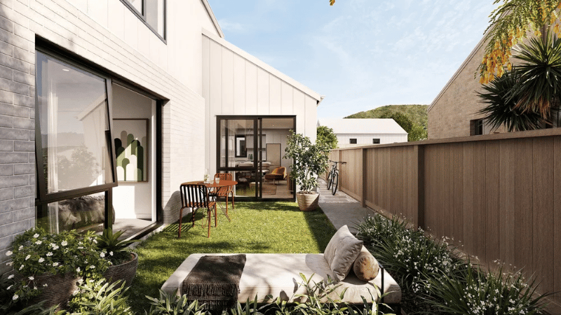 Private garden render at Campbell Village featuring large aluminium windows and glazed doors connecting to the home.