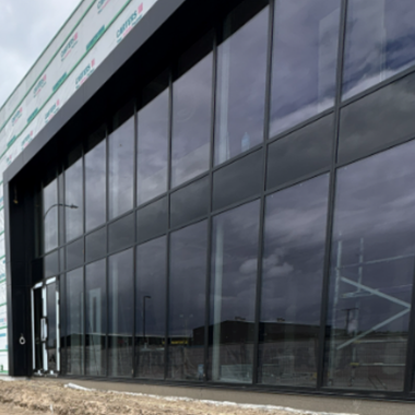 Full-height flushglaze façade delivering a sleek, high-performance solution for commercial projects, bringing together seamless design and enhanced natural light.