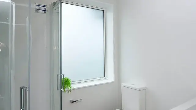 Bathroom at Hollard Grove, Avalon, Lower Hutt, with an obscure-glazed aluminium window beside the shower