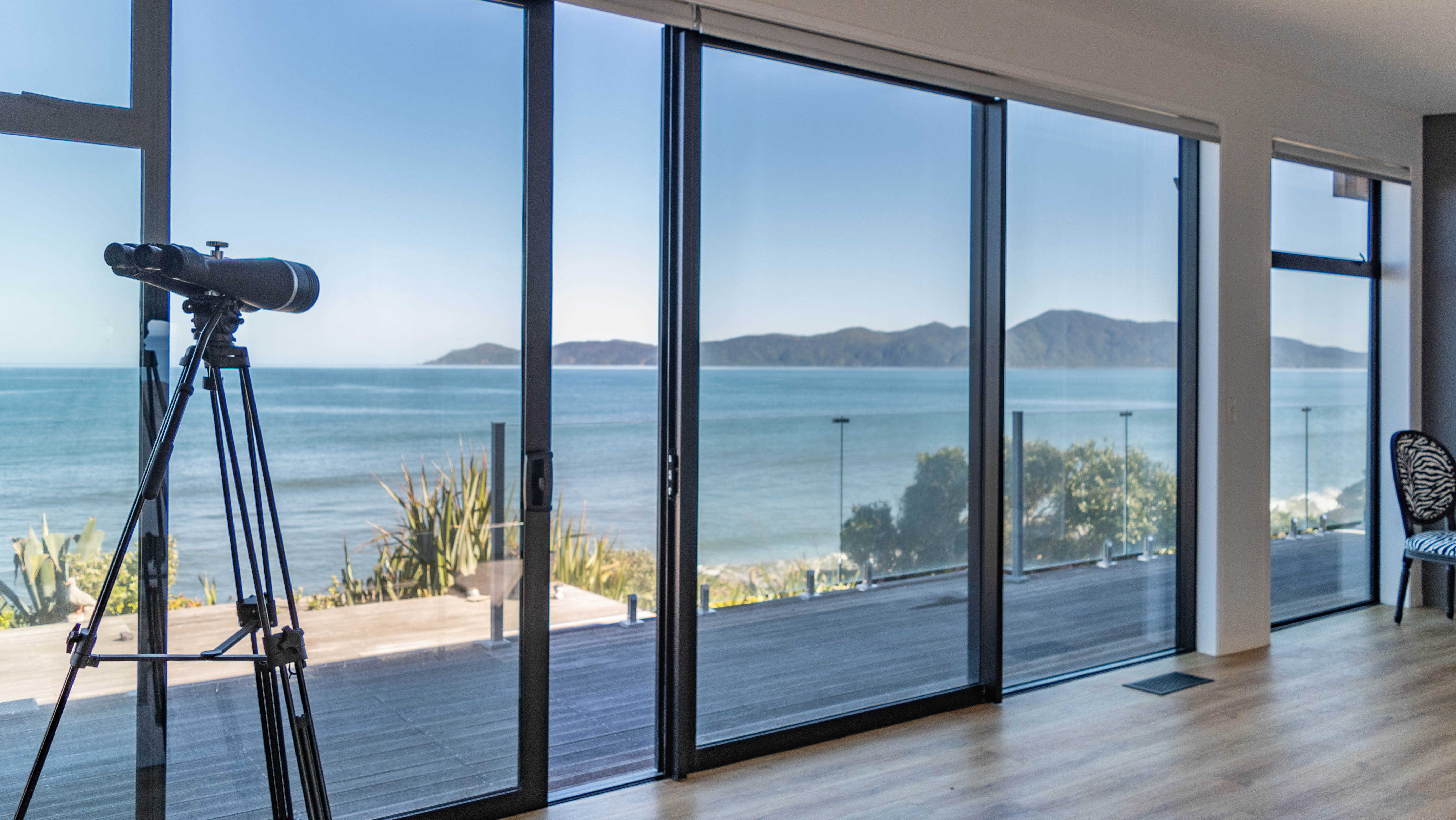 A telescope and a wide aluminium sliding door 