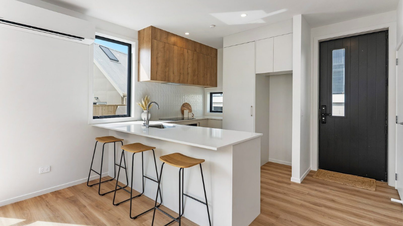 Modern townhouse kitchen featuring aluminium windows positioned to maximise daylight and ventilation.