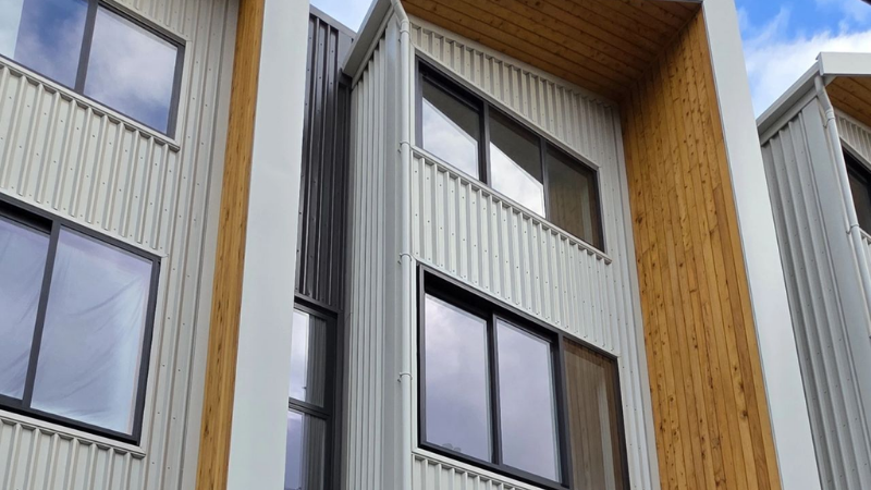 Close-up exterior view of aluminium windows installed within the modern façade of the St Giles Park View development.
