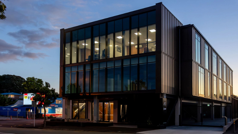 Leach Street Development in New Plymouth at dusk with illuminated offices behind the glazed façade.