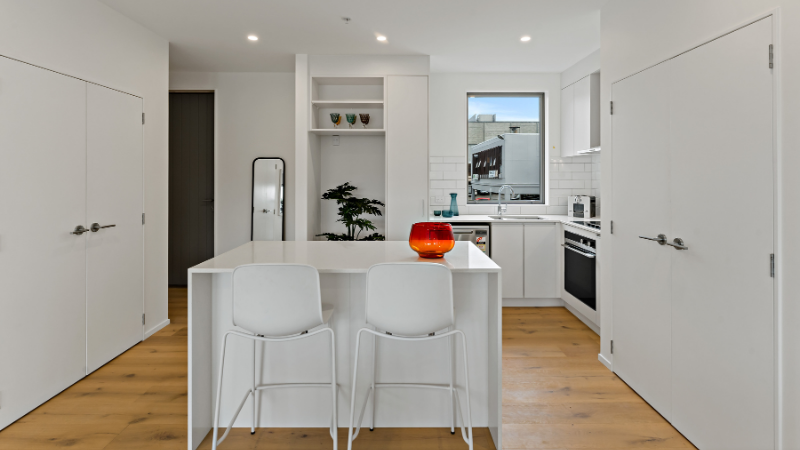 Contemporary apartment kitchen featuring fixed aluminium window bringing daylight into the living area.