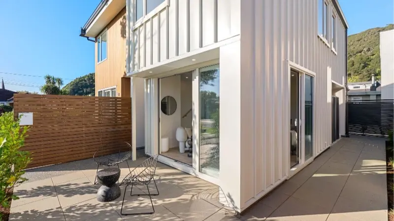 Outdoor patio featuring large aluminium sliding doors connecting indoor and outdoor living spaces.